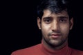 Portrait of young Indian man over dark Royalty Free Stock Photo