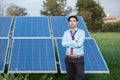 Portrait young indian technician or manager wearing formal cloths standing with solar panel. renewable energy,