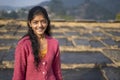 Portrait of a young indian village girl wearing winter clothes and smiling into the camera Royalty Free Stock Photo