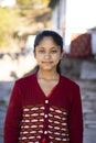 Portrait of a young indian village girl wearing winter clothes and smiling into the camera Royalty Free Stock Photo