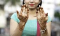 Portrait of a young Indian woman in casual style with mehendi or henna design on the both hands Royalty Free Stock Photo