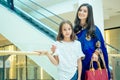 Portrait of a young indian woman wearing blue sari and gold bracelet having fun with her cute daughter in shopping mall Royalty Free Stock Photo