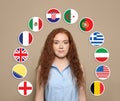 Portrait of young interpreter and flags of different countries on beige background