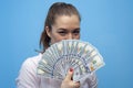 Portrait of young joyful business woman holding american dollars bills Royalty Free Stock Photo