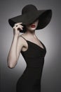 Portrait of young lady with black hat and evening dress Royalty Free Stock Photo