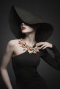 Portrait of young lady with black hat and evening dress Royalty Free Stock Photo