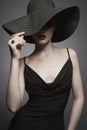 Portrait of young lady with black hat and evening dress Royalty Free Stock Photo