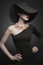 Portrait of young lady with black hat and evening dress Royalty Free Stock Photo