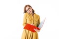 Portrait of young lady in eyeglasses talking on her cellphone and thoughtfully looking in open red folder on white Royalty Free Stock Photo