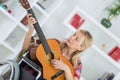 Portrait young lady in wheelchair playing guitar Royalty Free Stock Photo