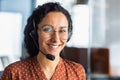 Portrait of a young Latin American woman in a headset. Call center He looks at the camera, smiles Royalty Free Stock Photo