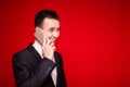 Portrait of young laughing businessman talking on cell phone Royalty Free Stock Photo