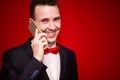 Portrait of young laughing businessman talking on cell phone Royalty Free Stock Photo