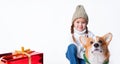 Portrait of young little girl with her pet puppy of corgi. Hugging near present. Concept christmas, new year and Royalty Free Stock Photo