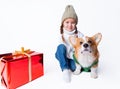 Portrait of young little girl with her pet puppy of corgi. Hugging near present. Concept christmas, new year and Royalty Free Stock Photo