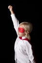 Portrait of young little girl wearing super hero costume in studio Royalty Free Stock Photo