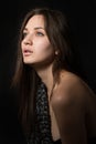 Portrait of young lonely woman in dark room