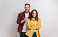 Portrait of young loving boyfriend and girlfriend smiling and holding hands over white background Royalty Free Stock Photo