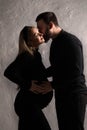 Man gently kissing his pregnant wife Royalty Free Stock Photo