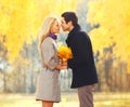 Portrait young loving couple kissing with yellow maple leafs in sunny autumn day Royalty Free Stock Photo