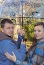 Portrait of a young loving couple smiling while standing under an umbrella Royalty Free Stock Photo