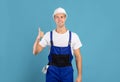 Portrait Of Young Maintenance Worker In Hardhat And Coveralls Showing Thumb Up