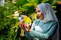 A portrait of young malay woman with surprise expression, holding an envelope of pocket money or raya angpao of Malaysian Currency Royalty Free Stock Photo