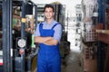 Portrait of young male assistant in uniform in workplace Royalty Free Stock Photo