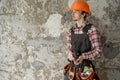 Portrait of young male builder on grunge wall background at construction site Royalty Free Stock Photo