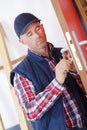 Portrait young male carpenter repairing door lock Royalty Free Stock Photo