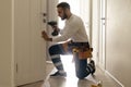 Portrait Young Male Carpenter Repairing Door Lock Royalty Free Stock Photo