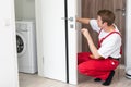 Portrait Young Male Carpenter Repairing Door Lock Royalty Free Stock Photo