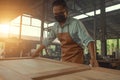 Portrait young male carpenter working woodworking on the wooden desk