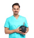 Portrait of young male doctor holding piggy Royalty Free Stock Photo