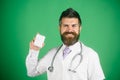 Portrait of young male doctor with of pills. Physician with beard dressed in white medical robe with pill. Medicine and health Royalty Free Stock Photo