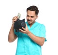 Portrait of young male doctor putting money Royalty Free Stock Photo