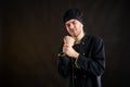 Young male dressed in a black chef suit has wrist pain Royalty Free Stock Photo