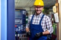 Portrait Of Male Engineer Operating CNC Machinery In Factory Royalty Free Stock Photo