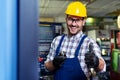 Portrait Of Male Engineer Operating CNC Machinery In Factory Royalty Free Stock Photo