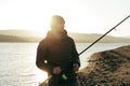 Portrait of a young male fisherman with fishing rod