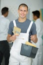 portrait young male painter standing with paint roller Royalty Free Stock Photo