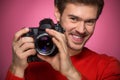 Portrait of young male with professional digital camera. Royalty Free Stock Photo