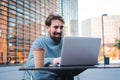 Portrait of young male remote working from coffee terrace and having work confrence video call with laptop. Business Royalty Free Stock Photo