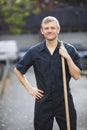 Portrait of young male street sweeper