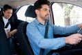 Taxi driver with passenger at back seat. Royalty Free Stock Photo