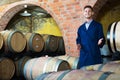 portrait of young male wine maker in coat working in winery cellaryoung wine maker in cellarman, male, young, working Royalty Free Stock Photo