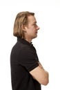 Portrait of young man, profile on white background. Arms crossed Royalty Free Stock Photo