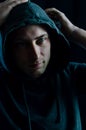 Portrait of a young man adjusting the hood on his head with his hands Royalty Free Stock Photo