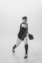 Portrait of young man, baseball player, pitcher with bubblegum playing, serving ball. Black and white photography Royalty Free Stock Photo