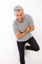 Young man with beard laughing against white background